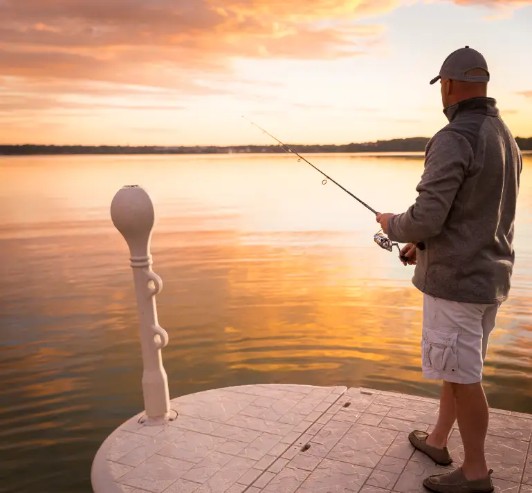 man fishing off of Wave Armor Floating Dock at Sunrise